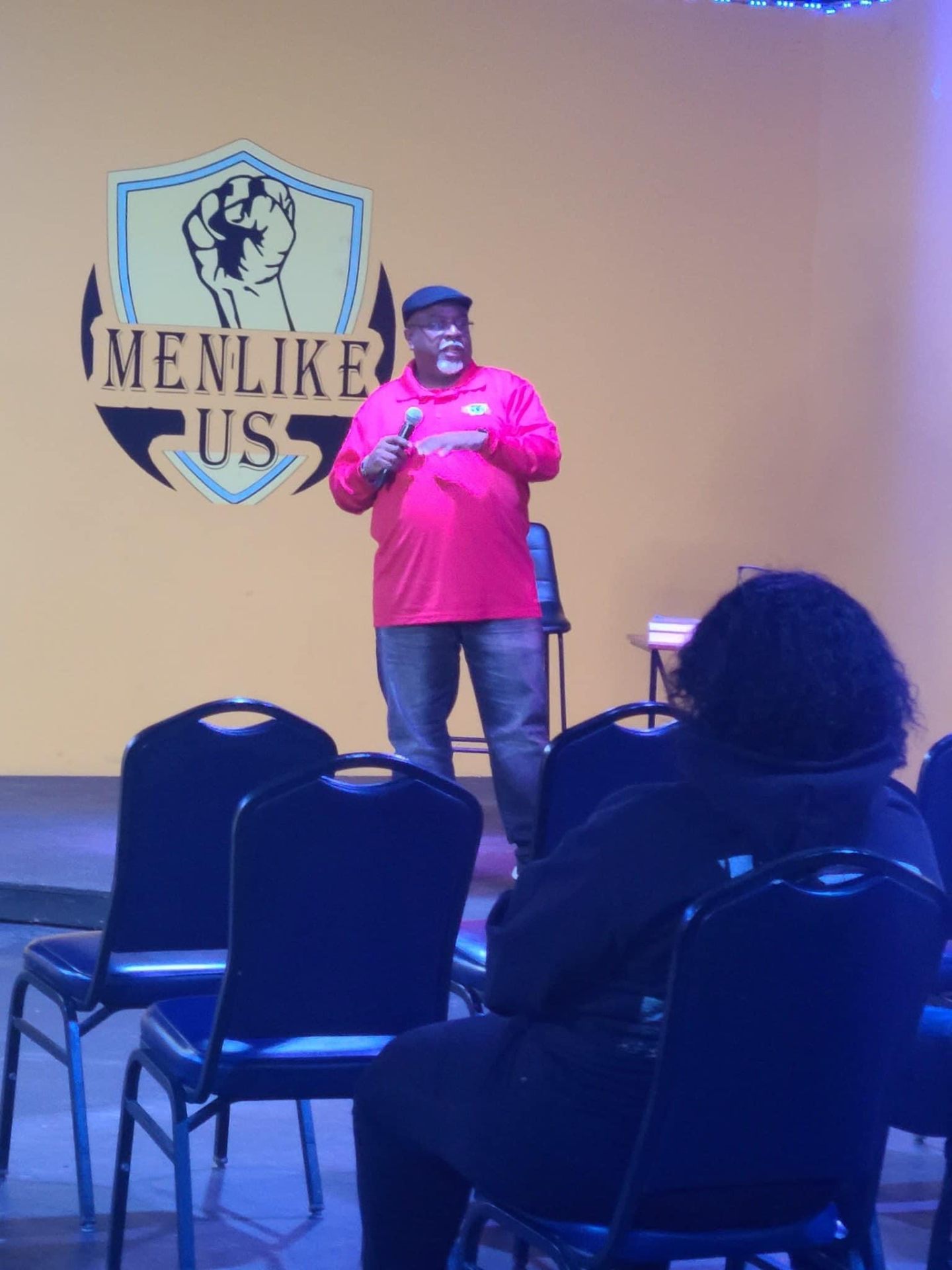 3D speaking on stage at a Men Like Us event